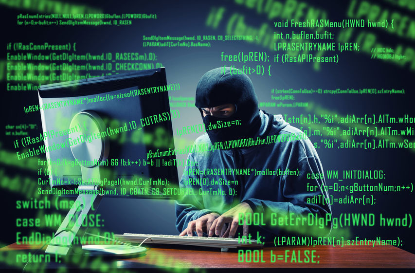 website security tips - hacker in mask stealing information from a computer.